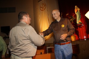 Mr. Ray Knight shakes hands with Mr. John Zelt, Class of 1963. Mr. Zelt handcrafted and donated a violin to ECCHS in honor of the 50th Anniversary.